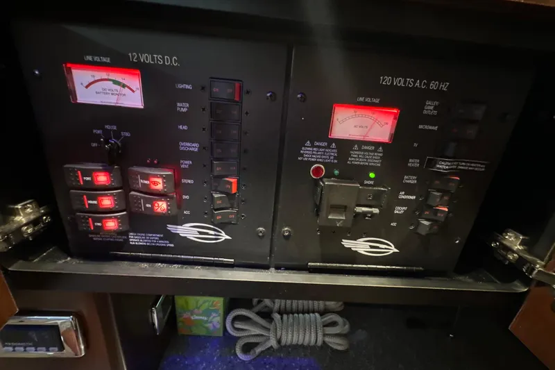 Slide: The Image of Control panel of a 2021 Chaparral 347 SSX boat, featuring voltage meters and switches. - 54