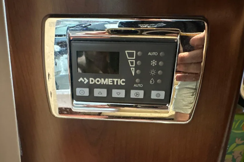 Slide: The Image of Dometic control panel on 2021 Chaparral 347 SSX boat, mounted on wooden surface. - 57