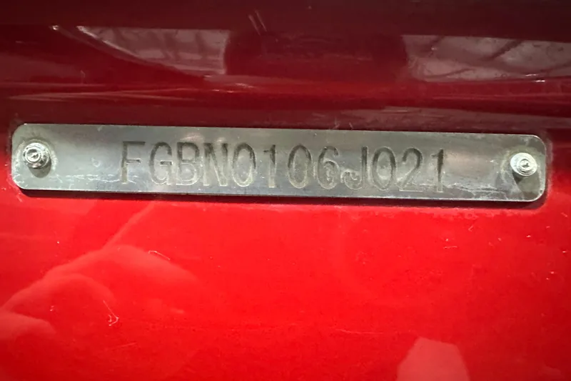 Slide: The Image of 2021 Chaparral 347 SSX boat identification plate with serial number on red surface. - 65