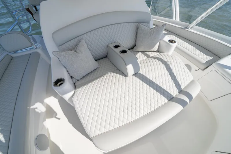 Slide: The Image of Luxurious seating on 2023 Viking 64 Convertible yacht with quilted upholstery and cup holders. - 15