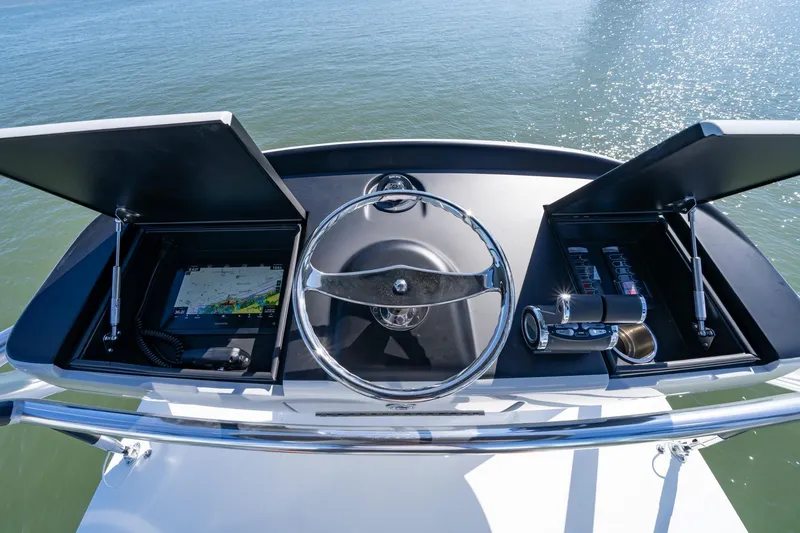 Slide: The Image of 2023 Viking 64 Convertible yacht helm with navigation controls and steering wheel. - 17