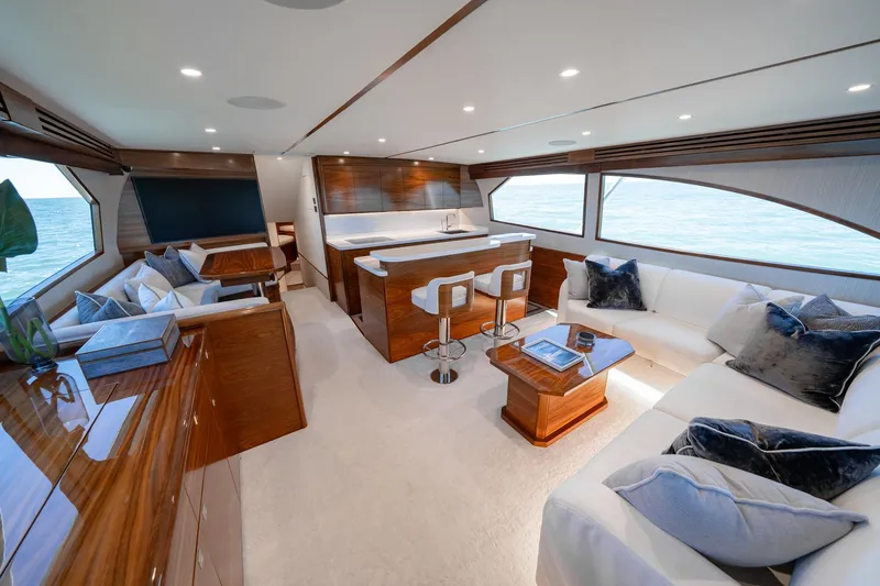 Slide: The Image of Luxurious interior of 2025 Viking 64 Convertible yacht with elegant seating and ocean view. - 22