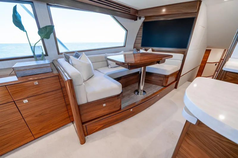Slide: The Image of Luxurious interior of 2023 Viking 64 Convertible yacht with elegant wood finishes and seating. - 24