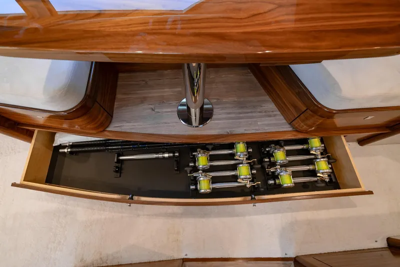 Slide: The Image of 2023 Viking 64 Convertible yacht interior with fishing rod storage drawer. - 25
