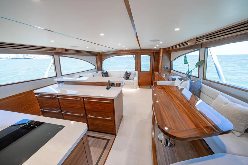 Slide: The Image of Luxurious interior of 2025 Viking 64 Convertible yacht with elegant wood finishes and ocean view. - 28