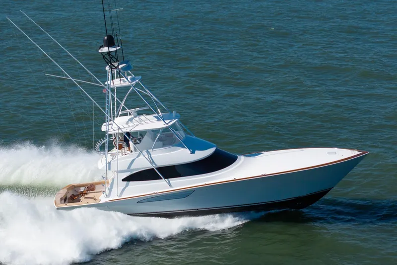 Slide: The Image of 2023 Viking 64 Convertible yacht cruising on open water at high speed. - 3