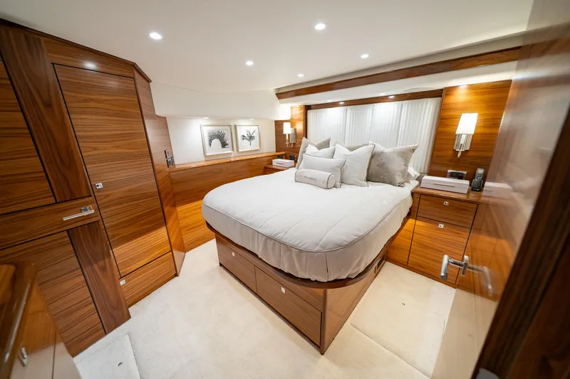 Slide: The Image of Luxurious bedroom interior of 2025 Viking 64 Convertible yacht with elegant wood finish. - 30