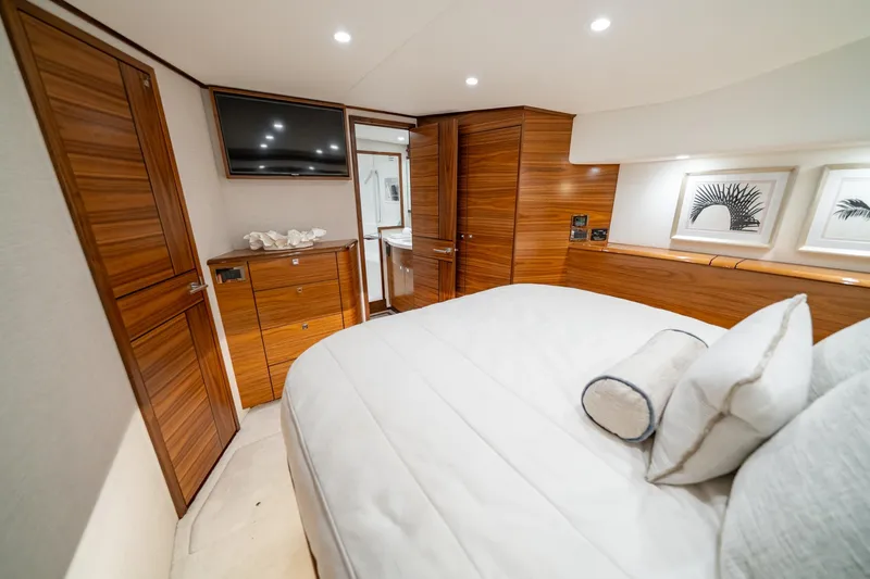 Slide: The Image of Luxurious cabin interior of 2025 Viking 64 Convertible yacht with wood accents and modern amenities. - 31