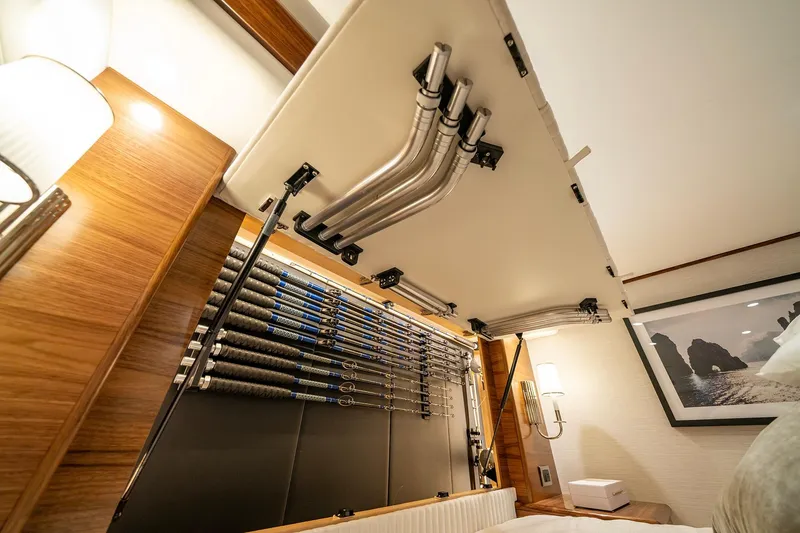 Slide: The Image of Fishing rod storage in 2025 Viking 64 Convertible yacht interior, featuring sleek design and wood accents. - 32