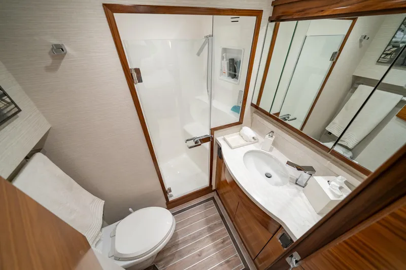 Slide: The Image of Luxurious bathroom in 2025 Viking 64 Convertible yacht with modern fixtures and elegant design. - 33