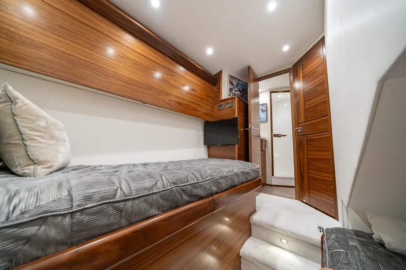 Slide: The Image of Luxurious cabin interior of 2025 Viking 64 Convertible yacht with wood paneling and modern amenities. - 35