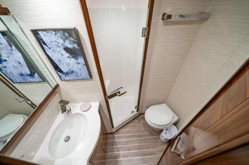 Slide: The Image of Luxurious bathroom in 2023 Viking 64 Convertible yacht with modern fixtures and elegant design. - 37