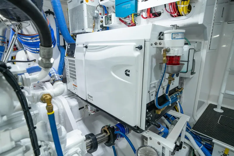 Slide: The Image of Engine room of 2023 Viking 64 Convertible yacht with Onan generator and complex wiring. - 43