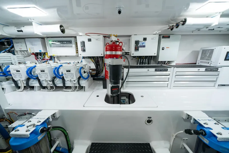 Slide: The Image of Engine room of 2023 Viking 64 Convertible yacht with advanced equipment and storage. - 44