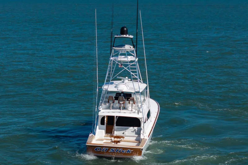 Slide: The Image of 2023 Viking 64 Convertible yacht cruising on open water. - 6