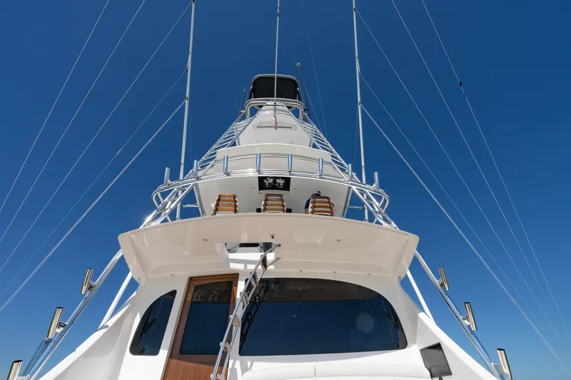 Slide: The Image of 2023 Viking 64 Convertible yacht, viewed from below against a clear blue sky. - 7