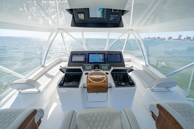Slide: The Image of 2025 Viking 64 Convertible yacht helm with advanced navigation systems and ocean view. - 8