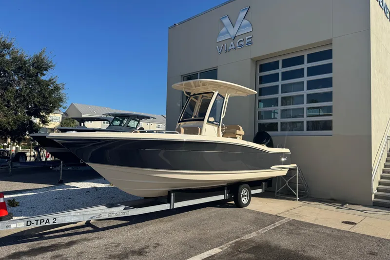 The Image of 2025 Scout 215 XSF boat on trailer outside Viage building. - 1