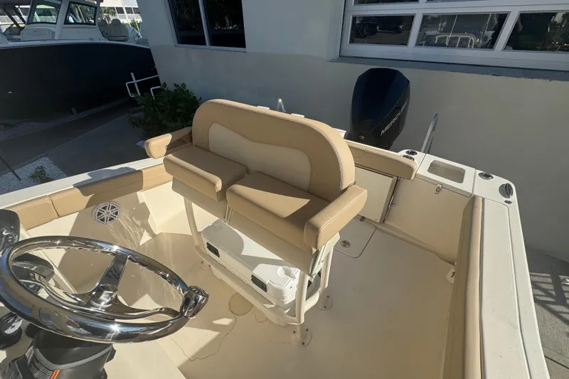 Slide: The Image of 2025 Scout 215 XSF boat interior with steering wheel and seating. - 6