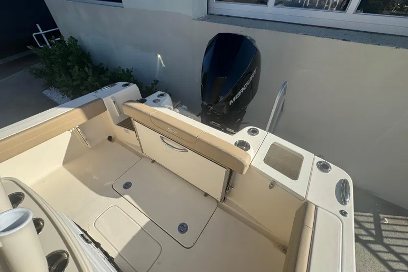 Slide: The Image of 2025 Scout 215 XSF boat interior with Mercury engine, featuring seating and storage compartments. - 7