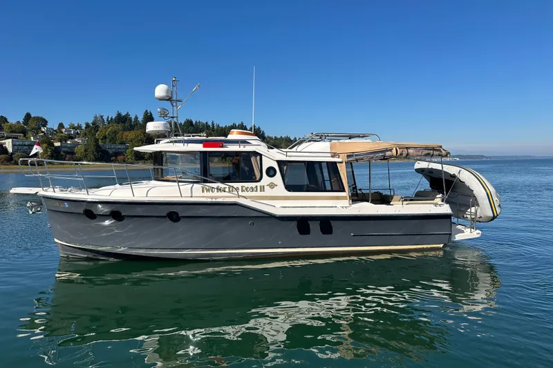 Slide: The Image of 2020 Ranger Tugs R-29 boat on calm water, clear sky background. - 0