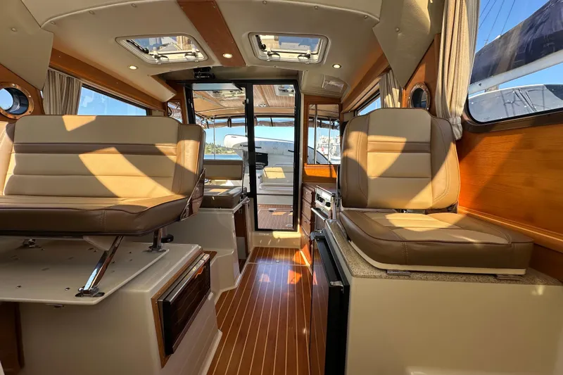 Slide: The Image of Interior of 2020 Ranger Tugs R-29 boat with luxurious seating and wood finishes. - 14