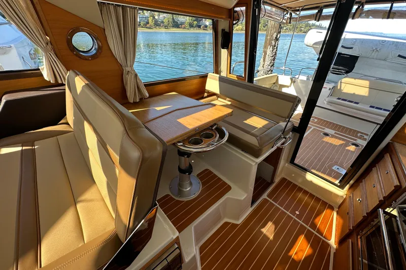 Slide: The Image of Interior of 2020 Ranger Tugs R-29 boat with seating and wooden flooring. - 17