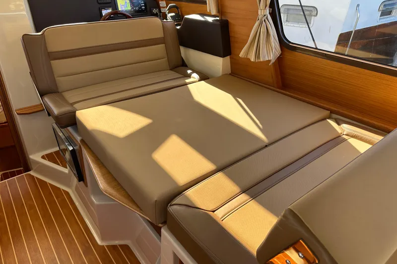 Slide: The Image of Interior of 2020 Ranger Tugs R-29 with beige seating and wood accents. - 18