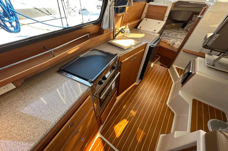 Slide: The Image of 2020 Ranger Tugs R-29 interior with modern kitchen and cozy cabin space. - 20