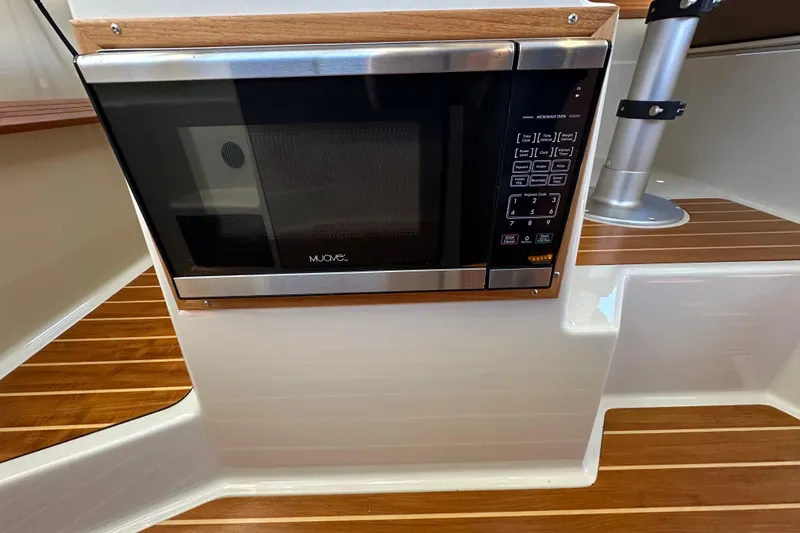 Slide: The Image of Microwave oven in 2020 Ranger Tugs R-29 boat interior with wood accents. - 23