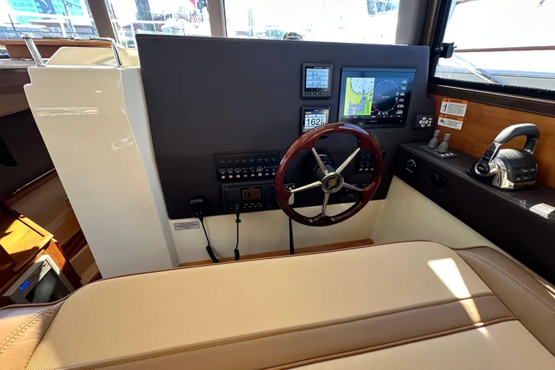 Slide: The Image of 2020 Ranger Tugs R-29 helm with navigation controls and steering wheel. - 26