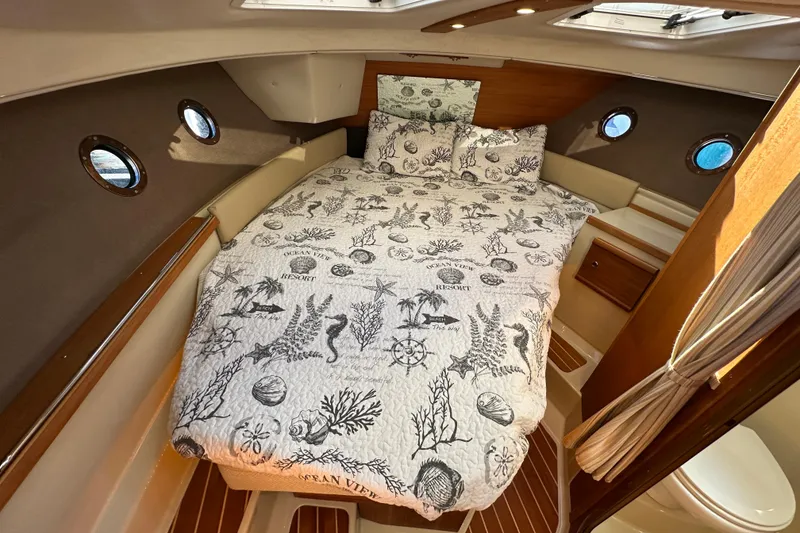 Slide: The Image of Cozy cabin interior of 2020 Ranger Tugs R-29 with nautical-themed bedding. - 32