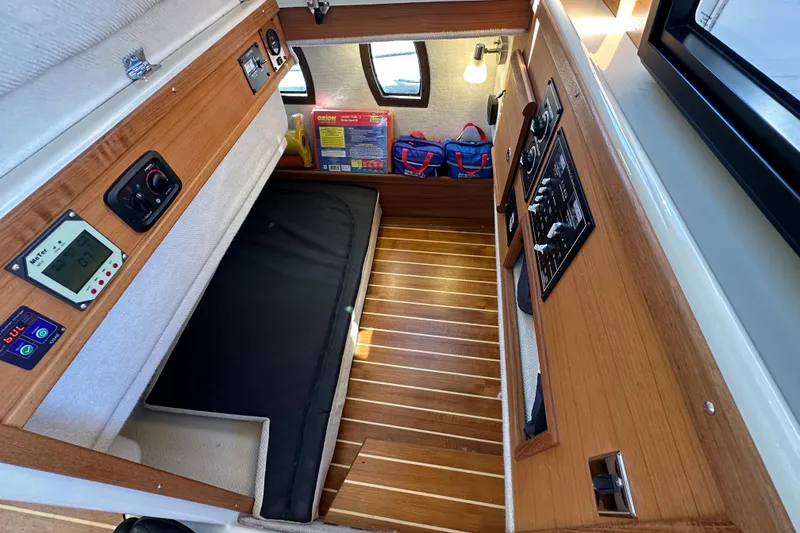 Slide: The Image of Interior cabin of 2020 Ranger Tugs R-29 with wood paneling and control panels. - 35