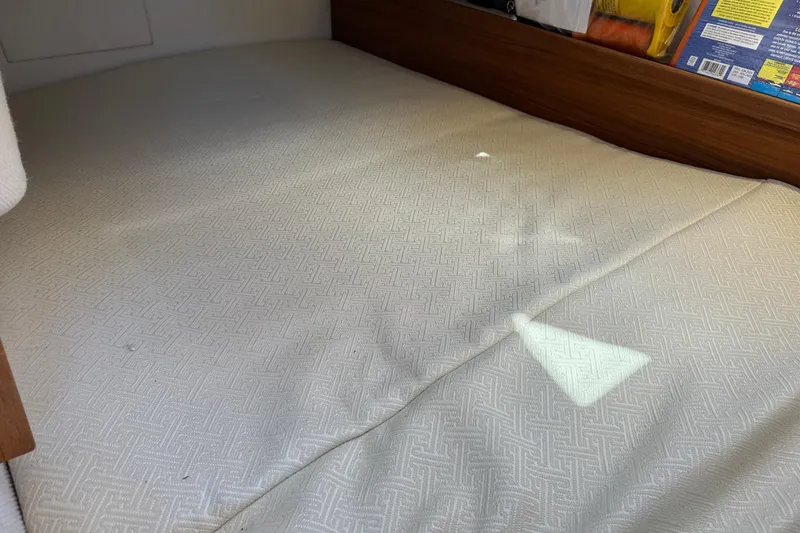 Slide: The Image of Interior cabin bed of 2020 Ranger Tugs R-29 boat, featuring patterned bedding. - 36