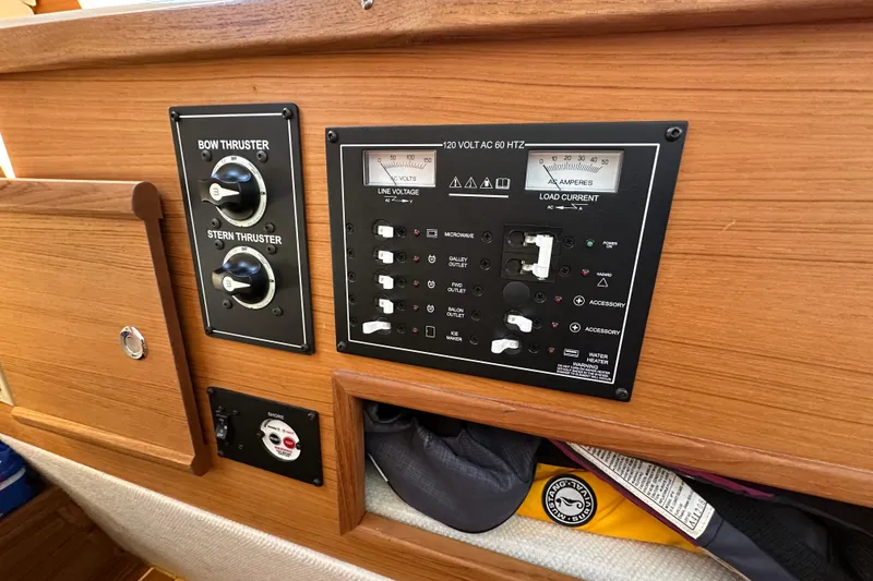 Slide: The Image of Control panel of a 2020 Ranger Tugs R-29 boat, featuring thruster and electrical controls. - 38