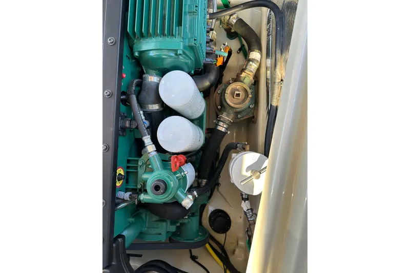 Slide: The Image of Engine compartment of 2020 Ranger Tugs R-29 with visible components and hoses. - 44