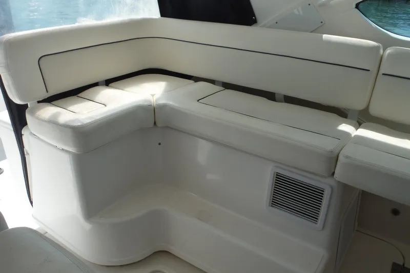 Slide: The Image of 2007 Tiara Yachts 3600 Open interior seating with white cushions and sleek design. - 10