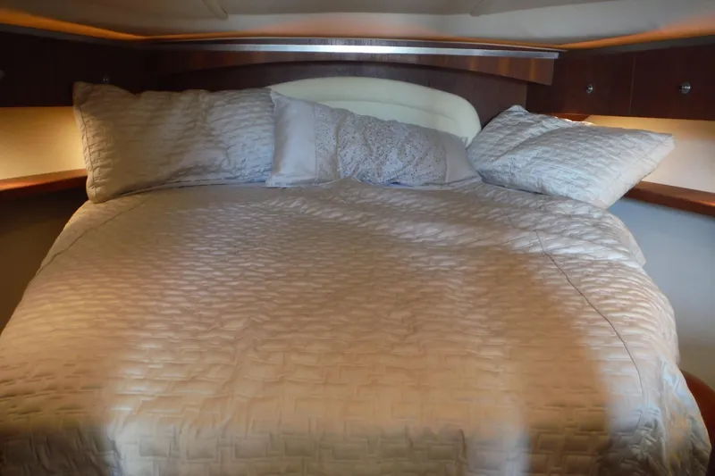 Slide: The Image of Luxurious bed in 2007 Tiara Yachts 3600 Open cabin, featuring elegant bedding. - 12