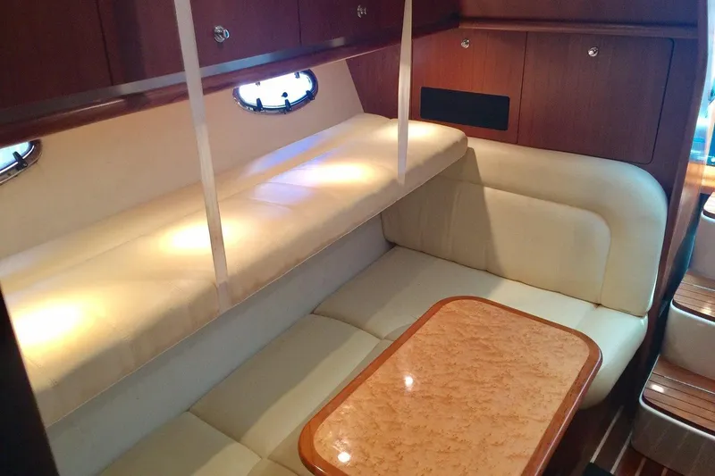 Slide: The Image of 2007 Tiara Yachts 3600 Open interior with cozy seating and elegant wood finishes. - 15