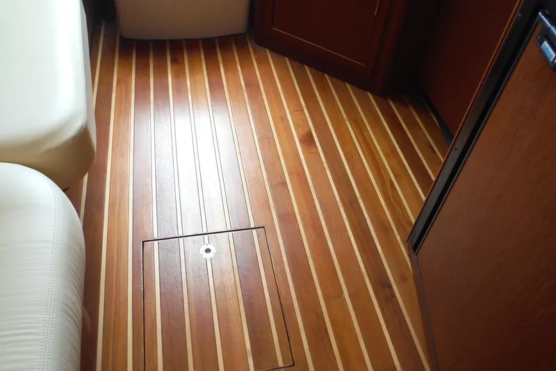 Slide: The Image of Teak flooring on 2007 Tiara Yachts 3600 Open, featuring elegant wood grain and hatch access. - 16