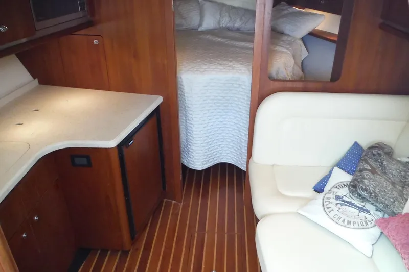 Slide: The Image of Interior of 2007 Tiara Yachts 3600 Open with cozy seating and bed. - 18