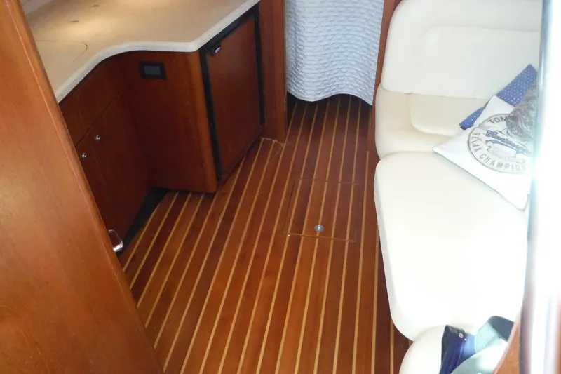 Slide: The Image of 2007 Tiara Yachts 3600 Open interior with wood flooring and white seating. - 19