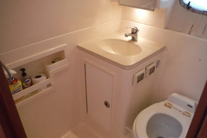 Slide: The Image of 2007 Tiara Yachts 3600 Open bathroom with sink, toilet, and storage shelves. - 20