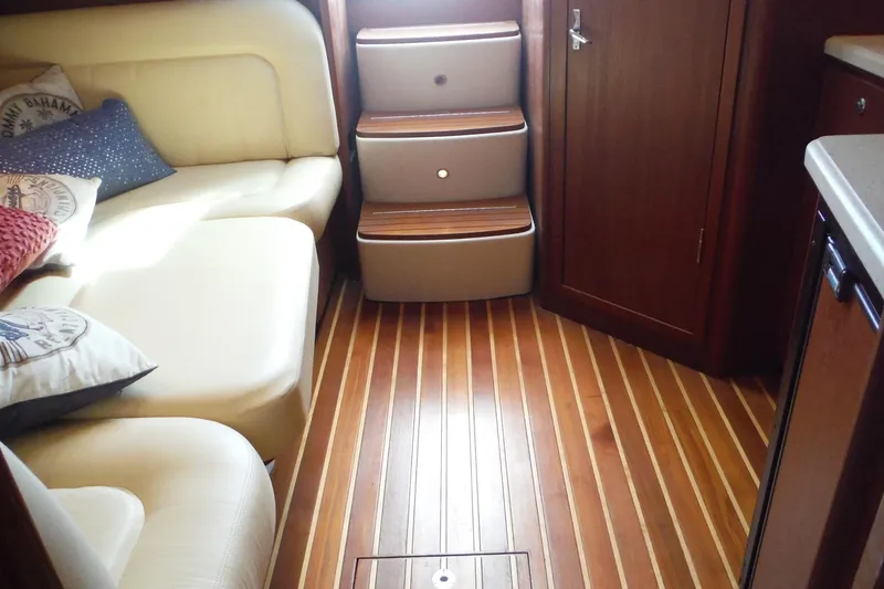 Slide: The Image of Interior of 2007 Tiara Yachts 3600 Open with wooden flooring and cream seating. - 25