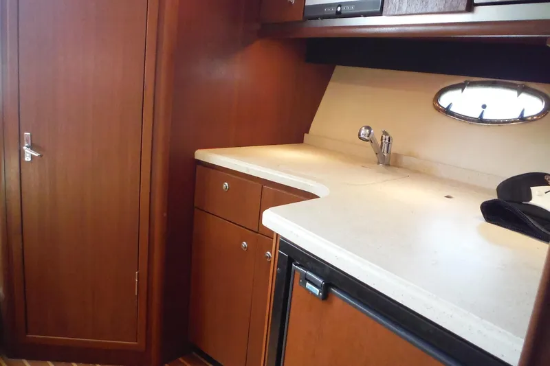Slide: The Image of 2007 Tiara Yachts 3600 Open interior kitchen with wooden cabinets and countertop. - 27