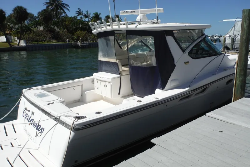 Slide: The Image of 2007 Tiara Yachts 3600 Open docked, featuring sleek design and spacious deck. - 3