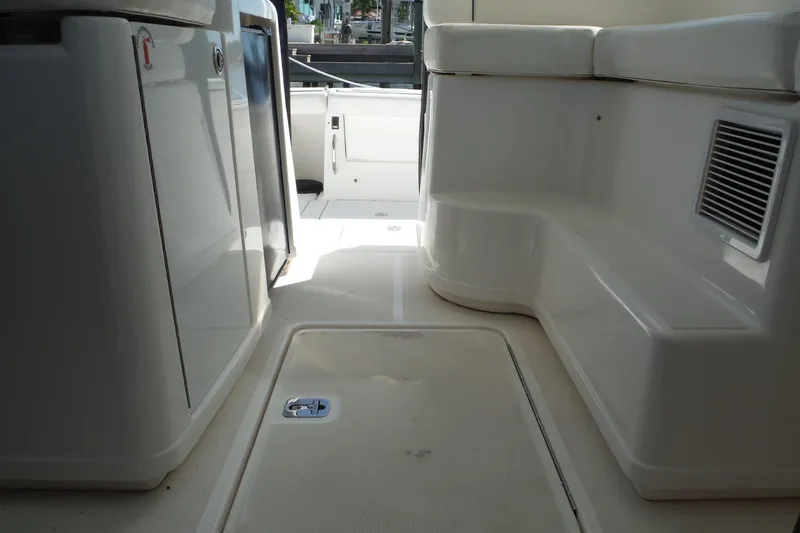 Slide: The Image of 2007 Tiara Yachts 3600 Open interior, featuring sleek white seating and storage compartments. - 30