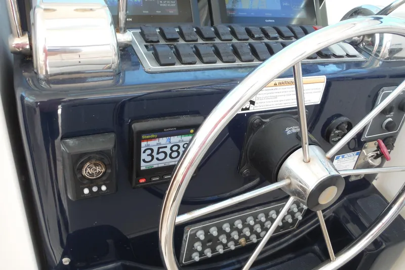 Slide: The Image of Steering wheel and controls of a 2007 Tiara Yachts 3600 Open boat. - 34
