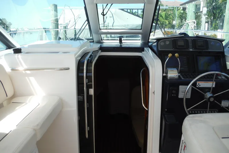 Slide: The Image of 2007 Tiara Yachts 3600 Open cockpit with helm, seating, and cabin entrance. - 38