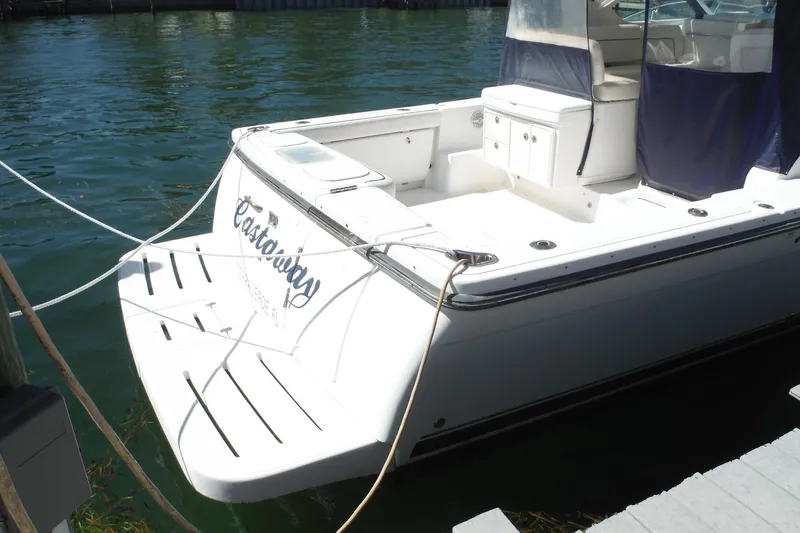 Slide: The Image of 2007 Tiara Yachts 3600 Open docked, featuring spacious deck and seating area. - 4